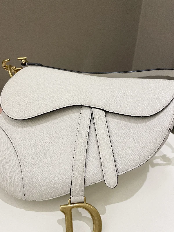 Christian Dior backpacks with a sleek, minimalist silhouetteDior Saddle Bag Ivory Epsom